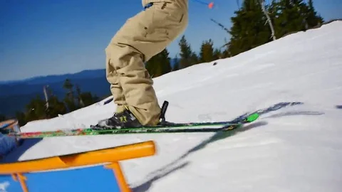 Quick shot of skier hitting the rail with a spin at Timberline Ski Area. Stock Footage 69172617