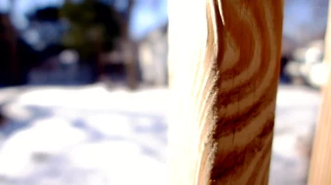 Quick side slide of a wood deck railing with snow covered ground in background. 스톡 동영상 46394647