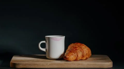 Quick snack. cup of tea and croissant Stock Photos