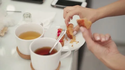 A quick snack for girlfriends at the workplace. Tea party with a cupcake. Stock Footage 144639791