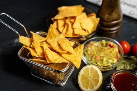 Quick snack with tortilla corn chips, spicy salsa and delicious hot guacamole Stock Photos