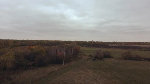 Quick start of the drone from the ground, in the field with the forest observati Stock Footage 162011595
