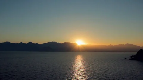Quick sunset over the mountains and sea, sunset timelapse Stock Footage 128534698