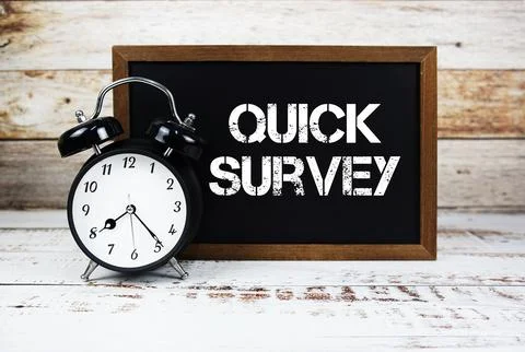 Quick Survey text message and alarm clock on wooden background Stock Photos