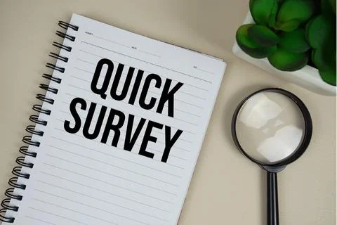 Quick Survey text on paper notebook with magnifying glass on beige leather .. Stock Photos