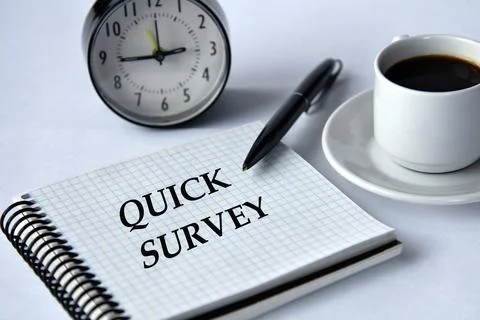 QUICK SURVEY - words in a notebook on a white background with a clock and a.. Stock Photos