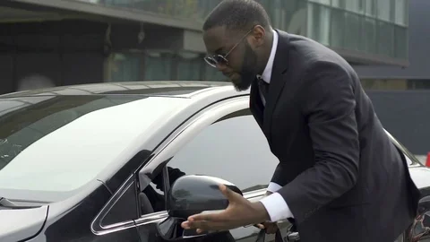 Quick-tempered man noticing little scratch on his new car and getting furious Stock Footage 82045667