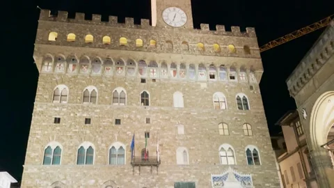 Quick tilt up of Palazzo Vecchio and its clock on the facade Stock Footage 259340326