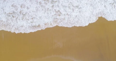 Quick time lapse of waves crashing onto the beach top down view aerial 4K Stock Footage 87572323