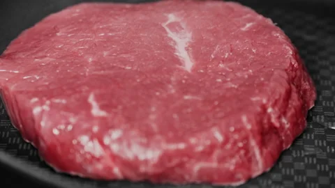 Quick timelapse of raw beef steak frying on black frying pan. Red meat cooking Stock Footage 131877988