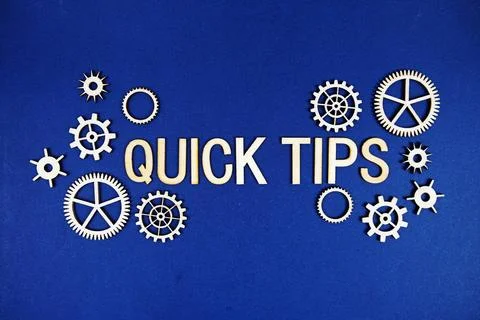Quick Tips alphabet letters with gears element on navy blue background Stock Photos