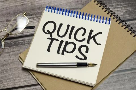 QUICK TIPS words on notebook on wooden background Stock Photos