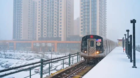 Quick train arrives to the empty open-air station. Snow falls on the platform in Stock Footage 335651914