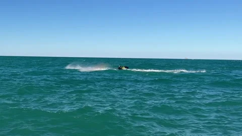 Quick turns on a jet ski on Lake Michigan. A tourist on a jet ski Stock Footage 211444288