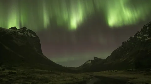 Quickly moving Aurora over valley Stock Footage 269712193