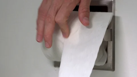 Quickly rolling toilet paper back onto the roll - Close Up Shot Video stock 128783151