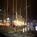 Quiet and cozy European town, white yachts moored near embankment, French flag 4k or 4k+ Resolution