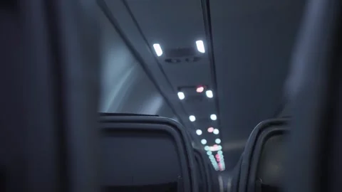 Quiet and empty airplane flight row of seats during nighttime with dimmed lights Stock Footage 304462829