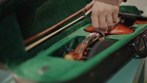 Quiet backstage preparation. Calm scene of musician preparing instrument Stock Footage 346561762