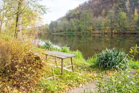 Quiet bench at Park by river Berunka Fall Autumn Trees. Autumn morning light Stock Photos