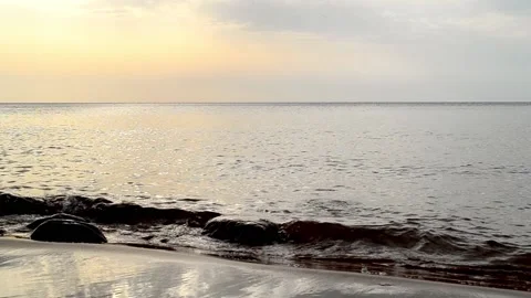 Quiet, calm sea surface in the evening before sunset. Small waves roll Stock Footage 153511194