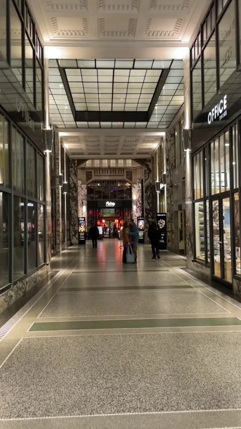 Quiet city corridor illuminated by soft skylight and neon reflections Stock Footage 335680486