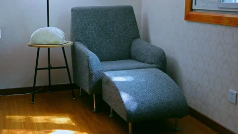 A quiet corner: a single sofa with sunlight streaming through the window. Stock Footage 330760574