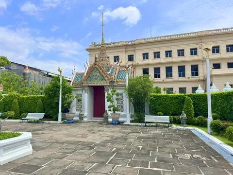 A quiet courtyard inside the palace featuring a small gate and neatly trimmed Stock Photos