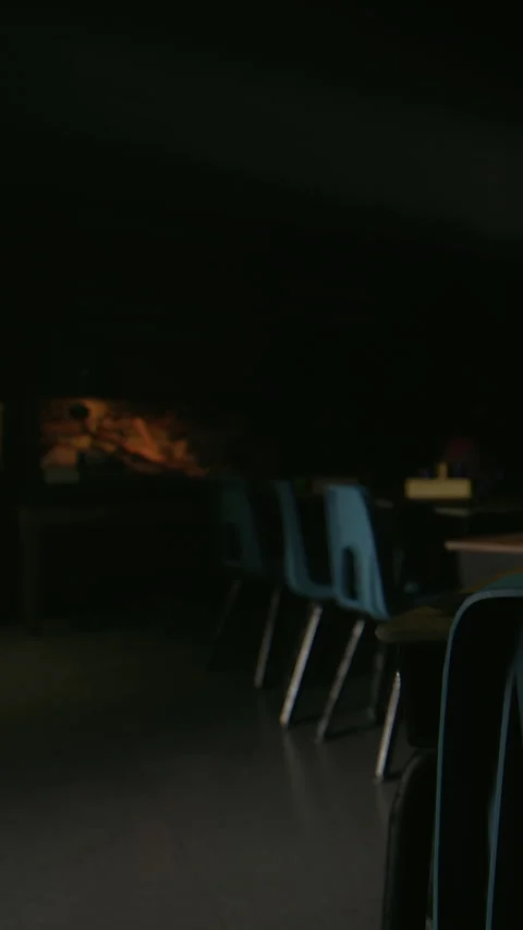 Quiet evening inside a classroom with dim lighting and empty chairs Stock Footage 340279406