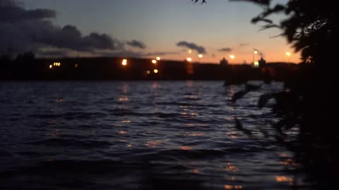 A quiet evening by the lake. Evening lights of the city Stock Footage 237769732