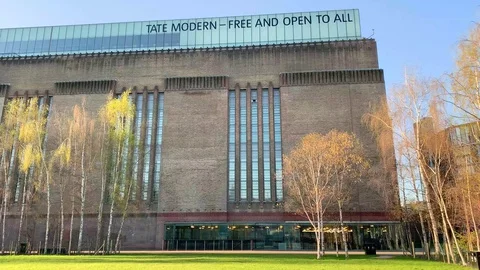 A quiet external, panning shot of Tate Modern Museum in London Stock Footage