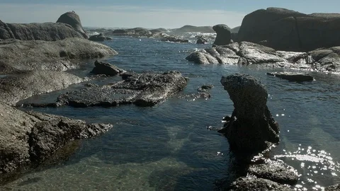 Quiet gulf between huge stones of the ocean coast Stock Footage 120438013