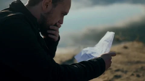 Quiet heartbreak as man reads devastating letter by peaceful lake Stock Footage 313606567