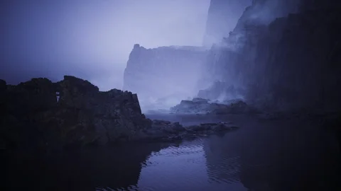 Quiet inlet embraced by sharp rocky formations and faint reflections Stock Footage 341587395