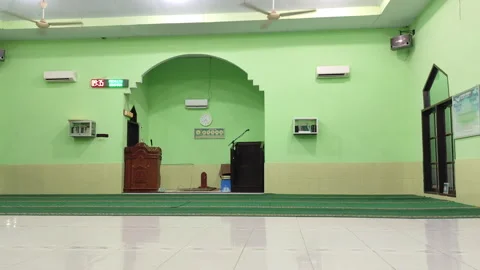 Quiet Interior of a Mosque with Green Walls and Wooden Pulpit Stock Footage 319904206