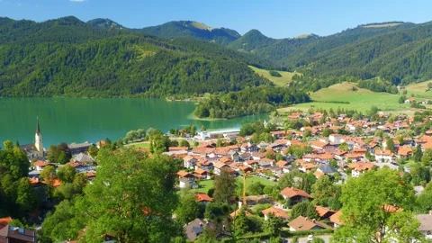 Quiet lake in Bavaria surrounded by alpine forest and meadows, offering summe Stock Footage 308324879