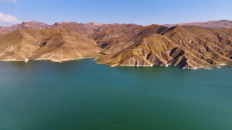 A quiet lake surrounded by mountains Stock Footage 310663140