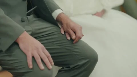 Quiet moment of hands intertwined during the wedding ceremony Video stock 324774677