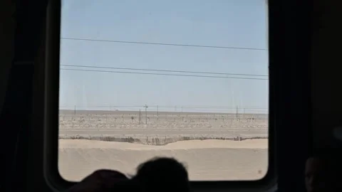 Quiet Moment of Reflection on a Train Journey Through the Xinjiang Desert Stock Footage 343708417