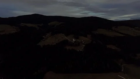 Quiet mountain slopes beneath dark evening sky Stock Footage 328493857