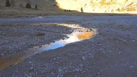 Quiet mountain stream flowing in a valley at sunset Stock Footage 71378422