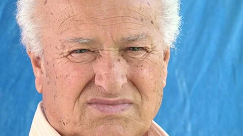 Quiet old man's portrait looking in camera turning front his head Stock Footage 64306306