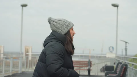 Quiet performer practicing dance routines against cloudy city backdrop. Female Stock Footage 334947495