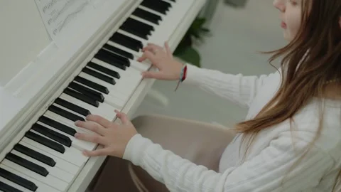 A quiet person practices the piano while sitting in his apartment. Stock-Footage 313748526