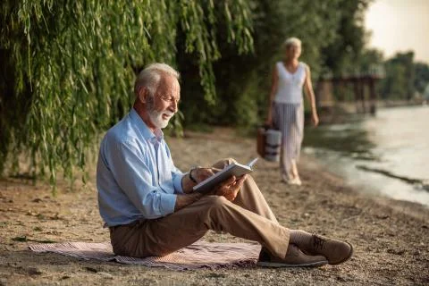 A quiet read by the river Stock Photos