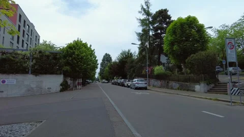Quiet residential street intersection with road signs in Zurich Stock Footage 334632773