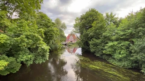Quiet river landscape with trees and house reflection in rural Germany Stock Footage 339994473