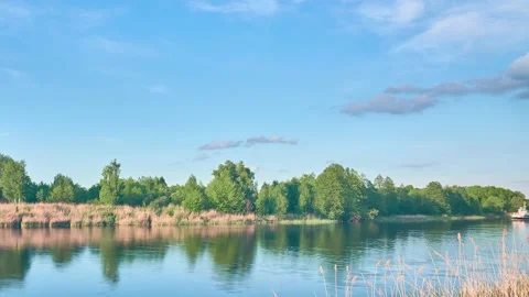 Quiet River. A small motorboat is sailing down the river. Timelapse. Pictures Stock Footage 157807620