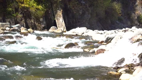 Quiet river water making its way over boulders Stock Footage 223186941