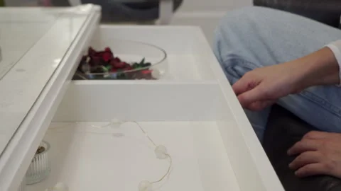 The Quiet Rumble of a Simple Task: Woman Opens a Desk Drawer at Home. Stock Footage 320566912